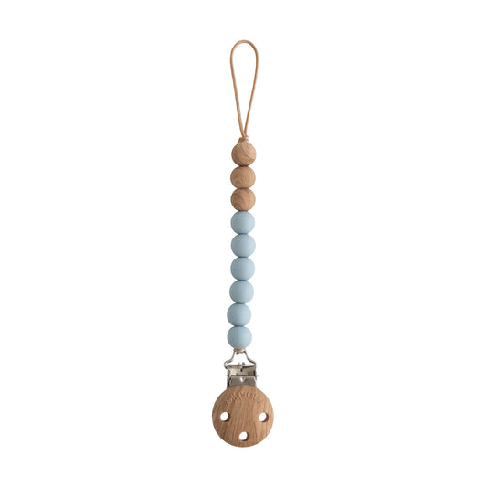 Fopspeenketting / fopspeenclip van het merk Mushie met blauwe siliconenkralen en natuurlijke houten kralen.